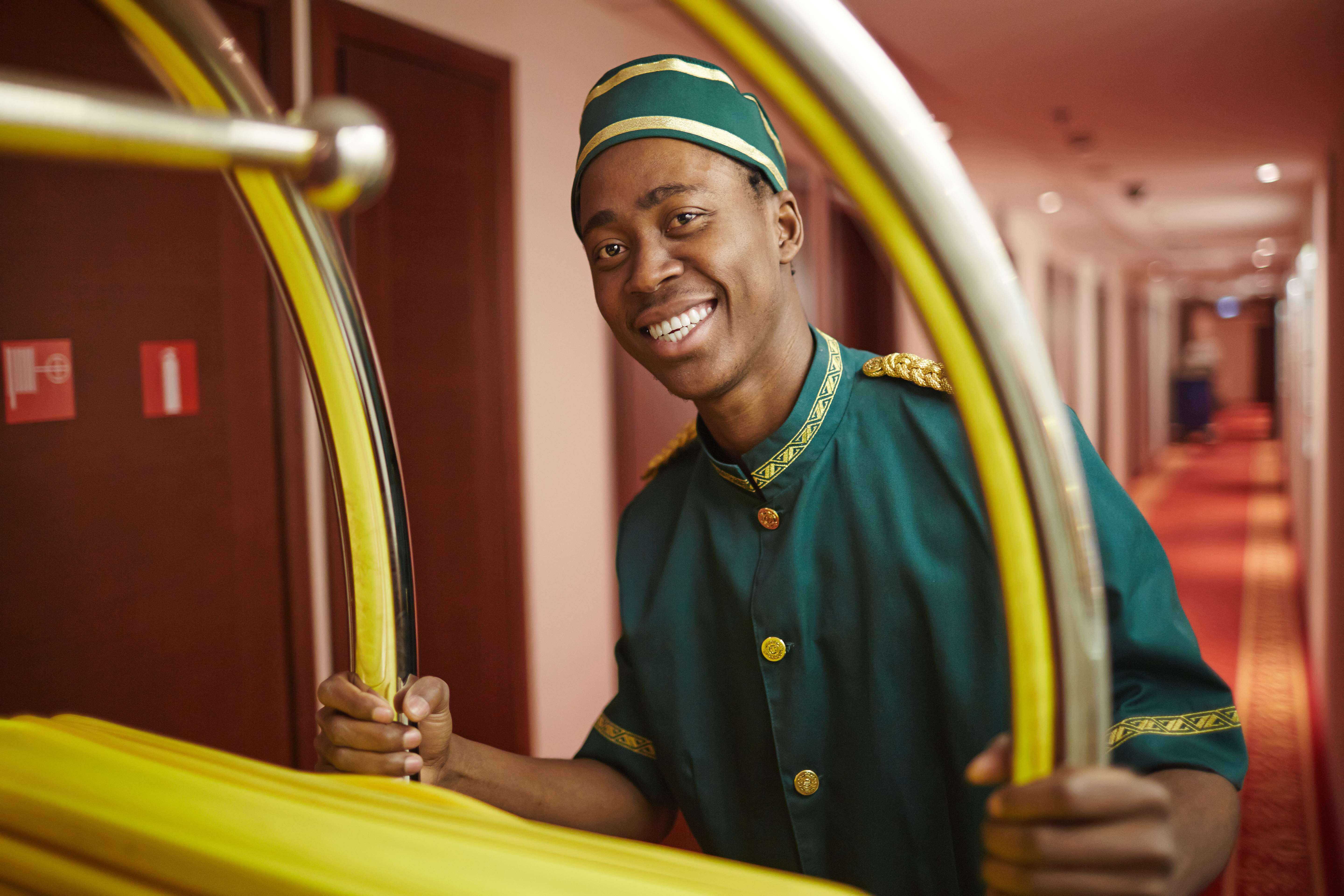 Happy porter doing his work in hotel